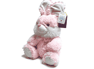 Coneja sentada rosa, gris o beige mediana.